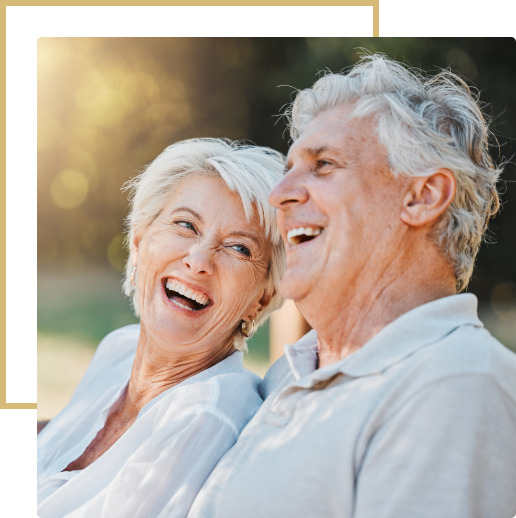 Happy senior couple laughing outdoors.