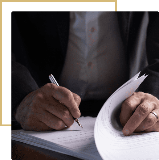 44 A person writing on paper with a pen.